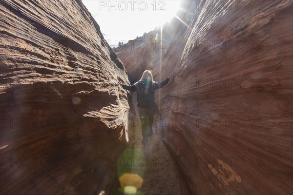 Senior hiker exploring slot canyon