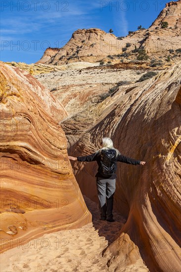 Senior hiker exploring slot canyon