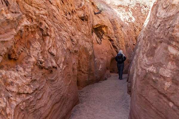 Senior hiker exploring slot canyon