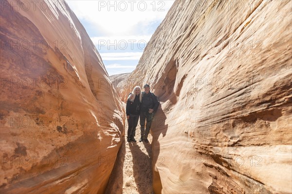 Senior hiker couple exploring slot canyon