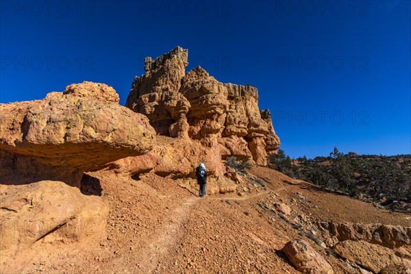 Senior hiker walking in rocky landscape