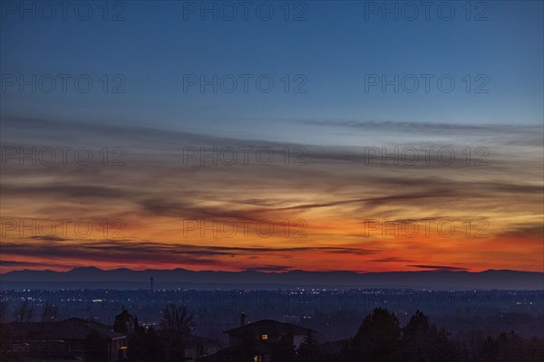 Sunset above city and mountains