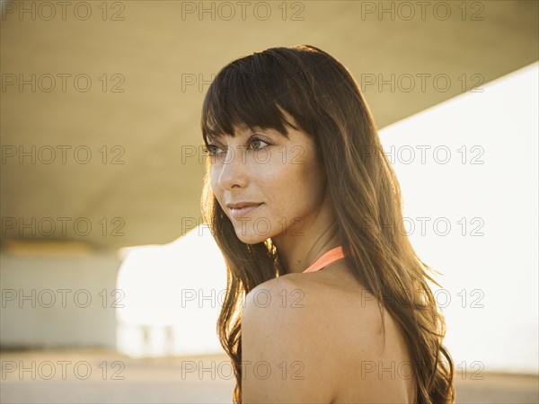 Portrait of pensive woman under bridge