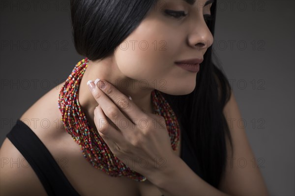 Close-up of woman touching neck