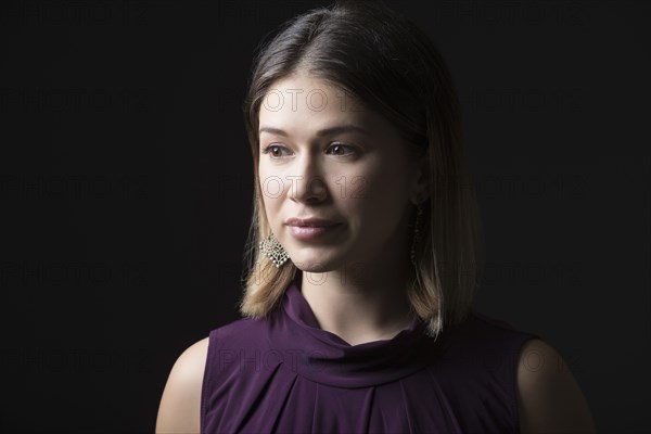 Studio portrait of woman in sleeveless purple top