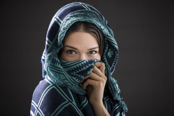 Studio portrait of woman with shawl on head