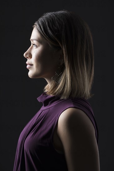 Profile of woman against black background