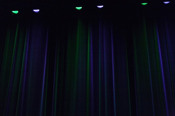 Stage curtain illuminated in green and blue
