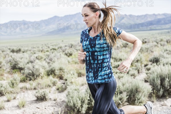 Woman jogging in desert landscape