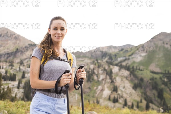 Portrait of smiling woman hiking in mountains