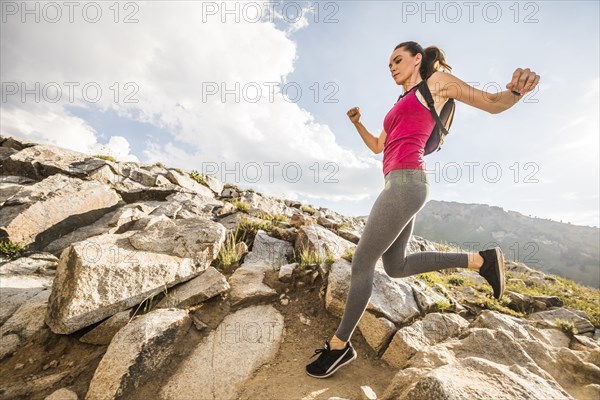 Woman jogging in mountains in summer