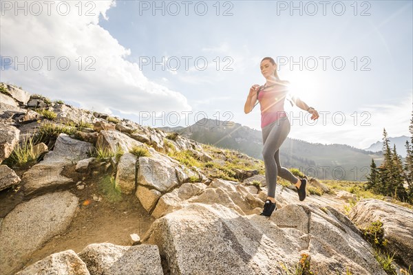 Woman jogging in mountains in summer