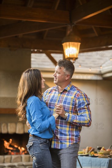 Mature couple dancing at home