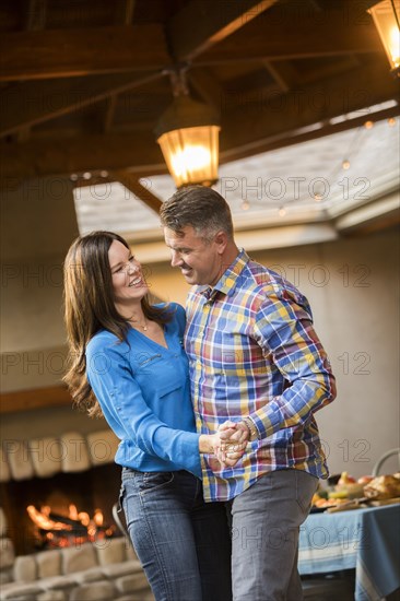 Mature couple dancing at home