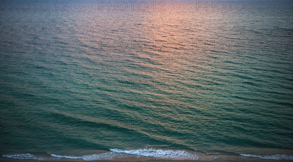 Rippled ocean surface reflecting sunlight