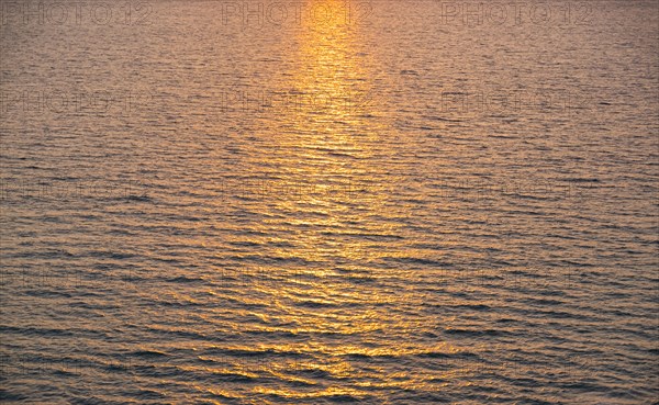 Rippled ocean surface reflecting sunlight