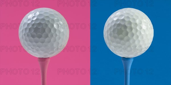 Golf balls on tee against pink and blue background