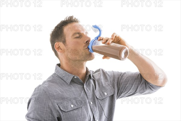 Studio shot of man drinking protein shake