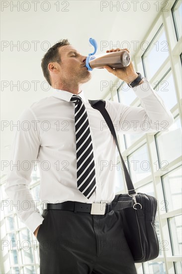 Businessman drinking protein shake in office