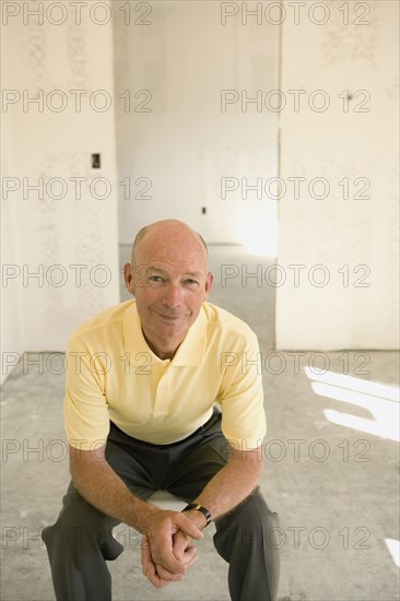 Senior man sitting in empty room