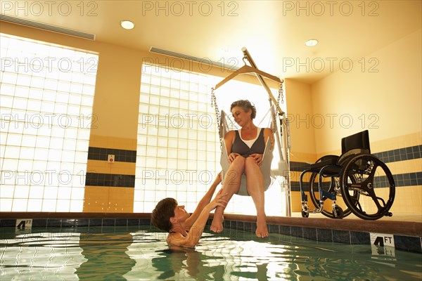 Physical therapist and patient in hospital pool