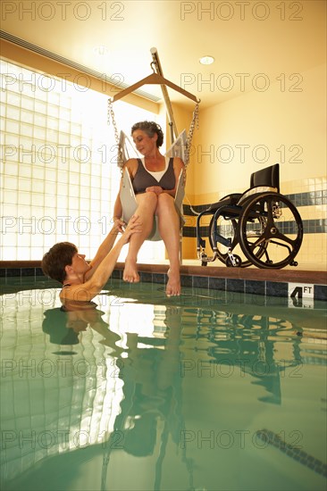 Physical therapist and patient in hospital pool