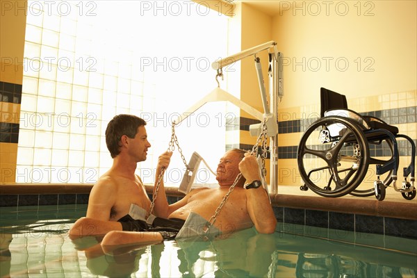 Physical therapist and patient in hospital pool