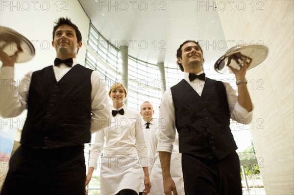 Group of waiters carrying trays