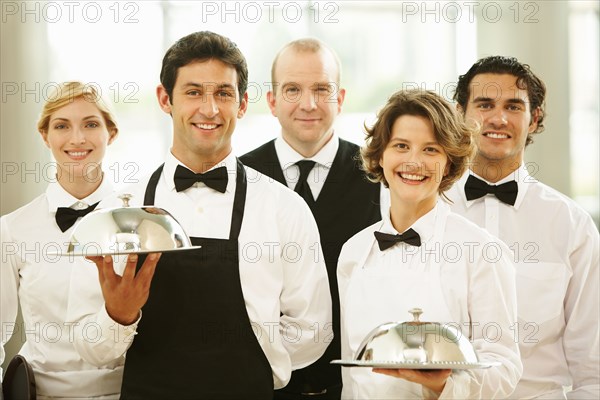 Group of waiters carrying trays