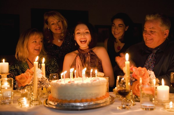 Group of friends celebrating birthday in restaurant