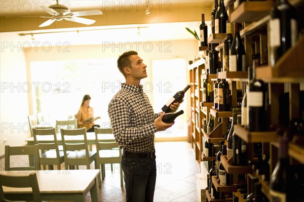 Man choosing wine in shop