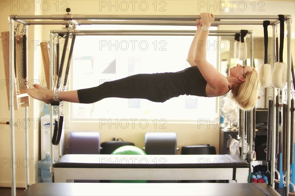 Woman training on pilates equipment