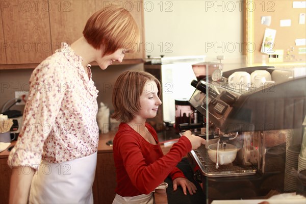 Owner and daughter (10-11) in small bakery