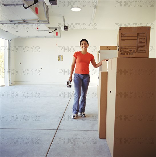 Woman in garage with moving boxes