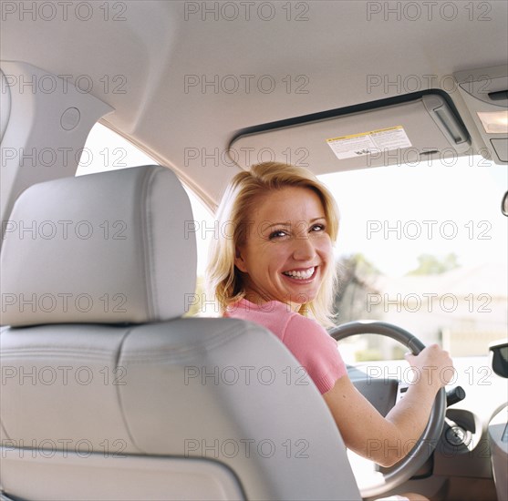 Portrait of woman sitting in drivers seat of car