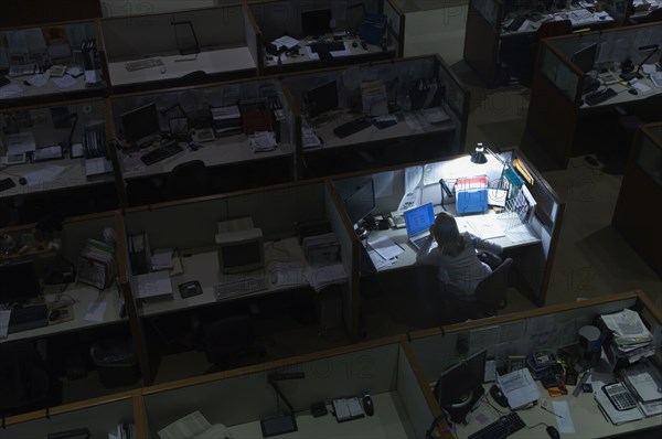 Woman working late at night in office