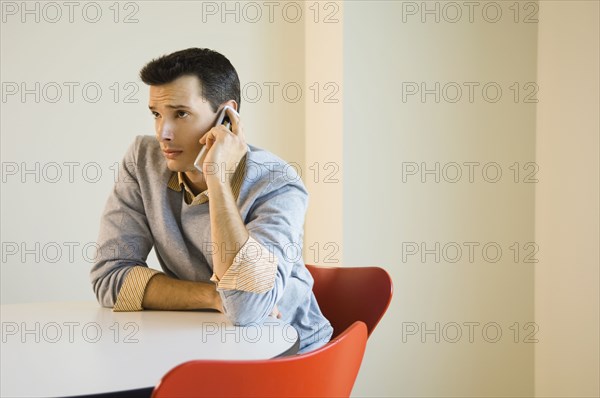 Man sitting at table using mobile phone