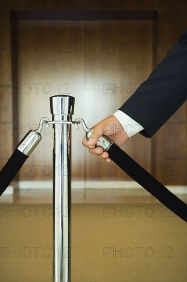 Man holding velvet rope