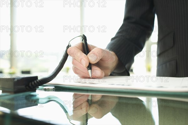 Man signing in at reception desk