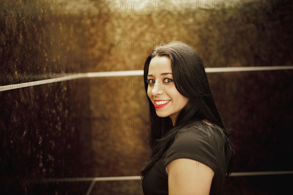 Portrait of young woman in elevator