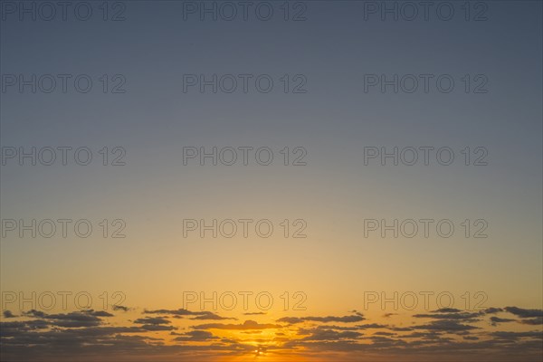 Golden sunrise sky with low clouds