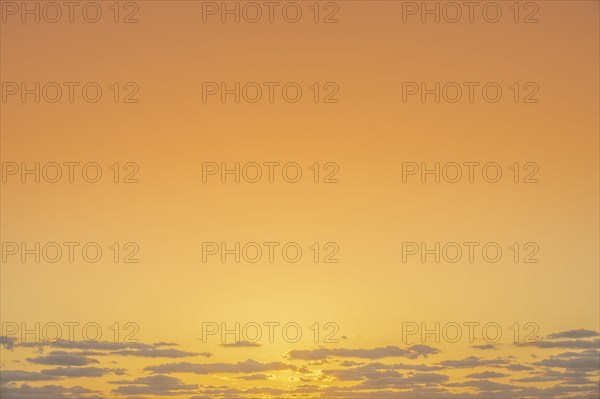 Golden sunrise sky with low clouds