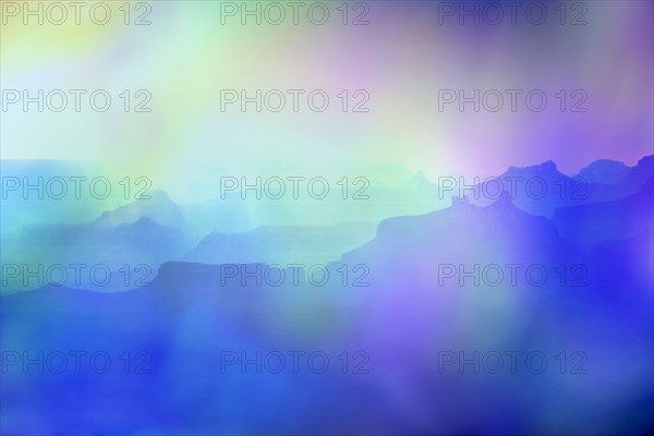 Silhouettes of rock formations in blue light at sunset