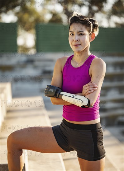 Portrait of athlete woman with prosthetic arm