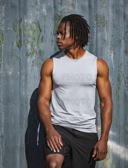 Portrait of athlete man against wall