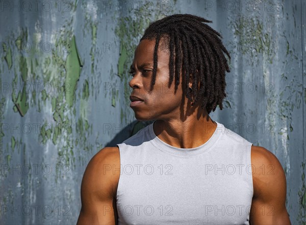 Portrait of athlete man against wall