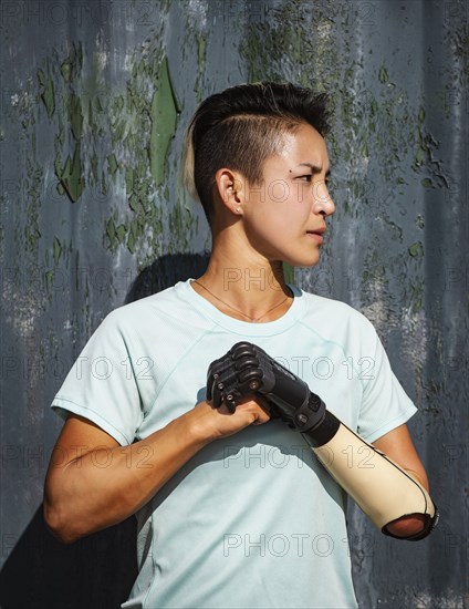 Portrait of athlete woman with prosthetic arm