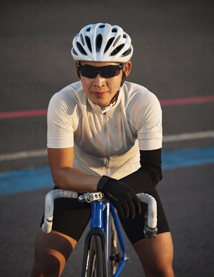 Portrait of athletic woman with prosthetic arm on bicycle