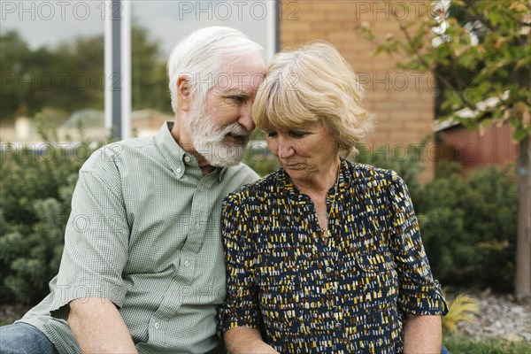 Portrait of senior couple in backyard