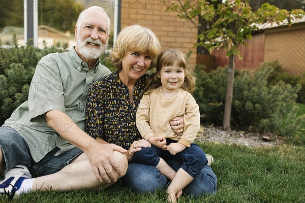 Portrait of smiling grandparents with granddaughter